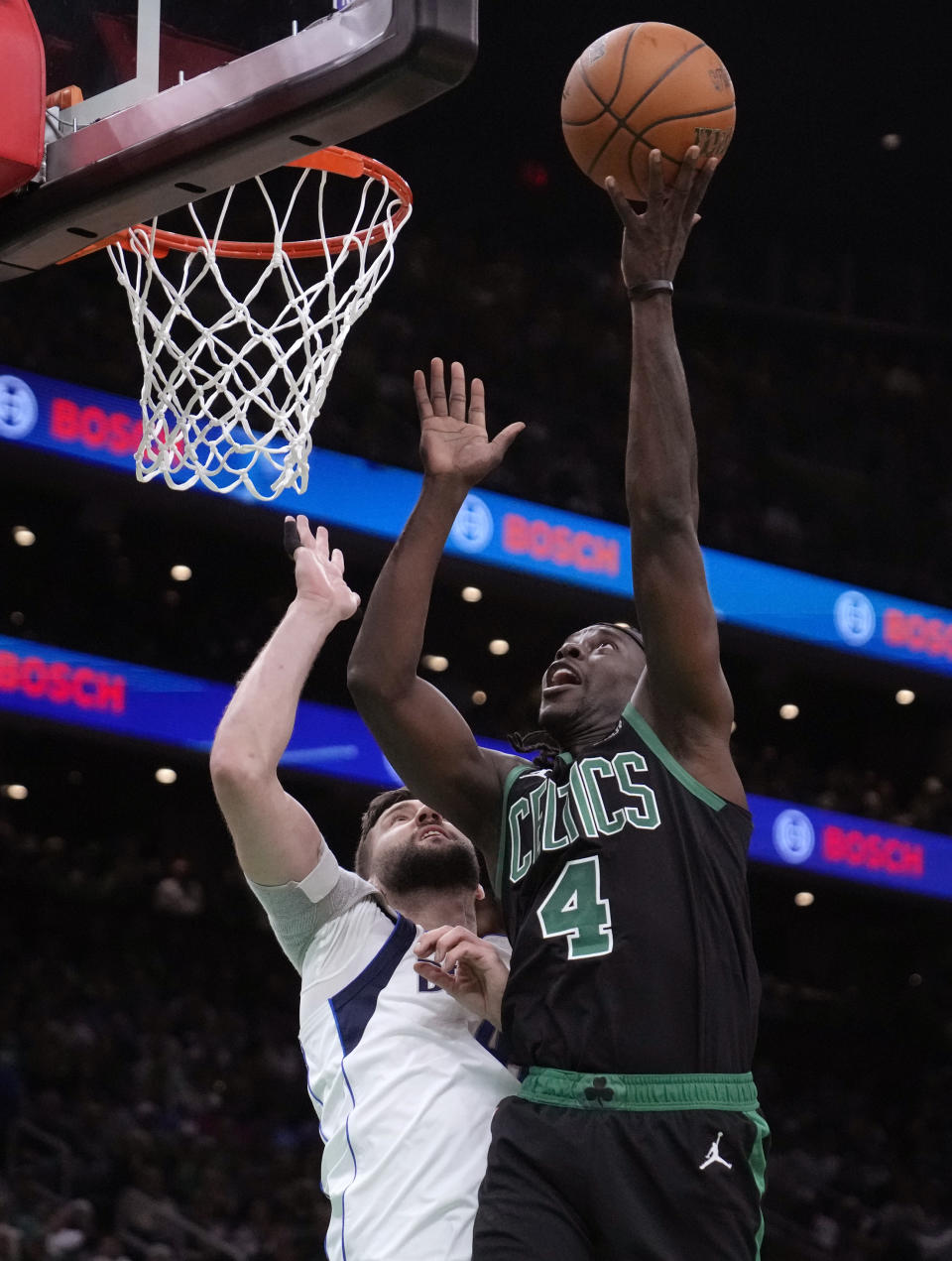 Boston Celtics guard Jrue Holiday shoots over Dallas Mavericks forward Maxi Kleber (42) during the first half of Game 2 of the NBA Finals basketball series, Sunday, June 9, 2024, in Boston. (AP Photo/Steven Senne)