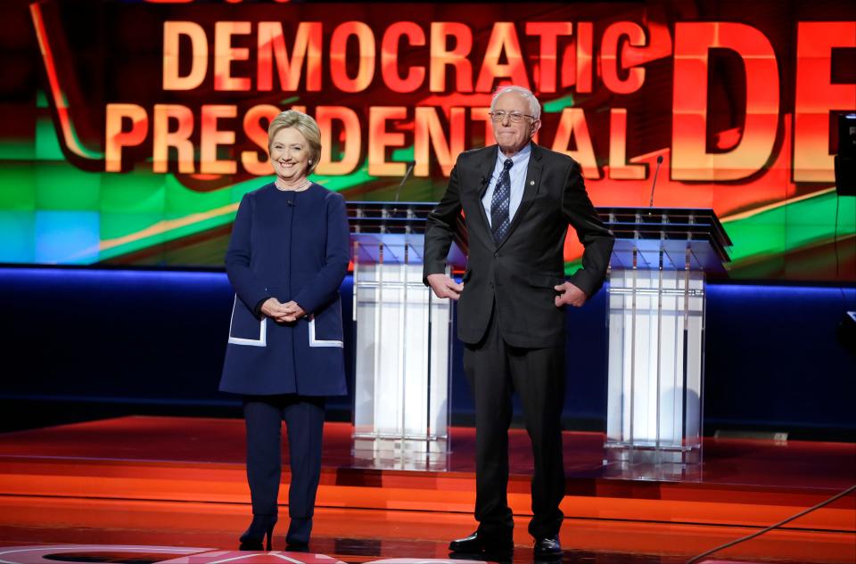 Democratic presidential candidates Hillary Clinton, left, and Sen. Bernie Sanders, I-Vt., stand on stage before a Democratic presidential primary debate at the University of Michigan-Flint on March 6, 2016.