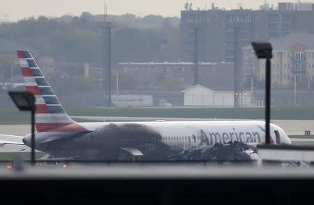 Soot covers the fuselage of an American Airlines jet that blew a tire, sparking a fire and prompting the pilot to abort takeoff before passengers were evacuated from the plane via emergency chute, at O'Hare International Airport in Chicago, Illinois, U.S.October 28, 2016. REUTERS/Jim Young