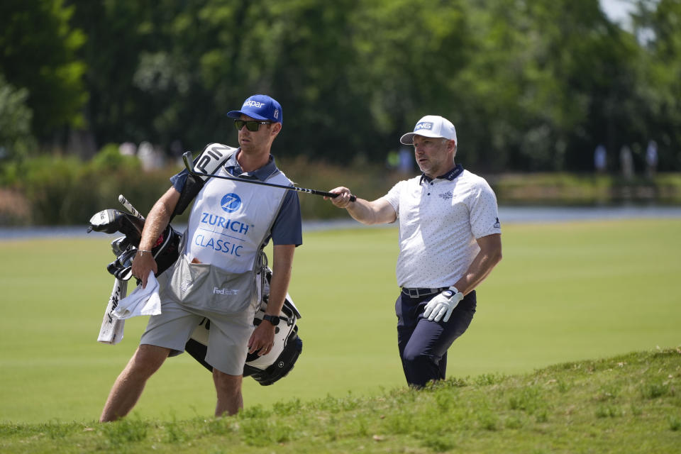 David Skinns, of England, discusses his shot with his caddie on the 18th fairway during the second round of the PGA Zurich Classic golf tournament at TPC Louisiana in Avondale, La., Friday, April 26, 2024. (AP Photo/Gerald Herbert)