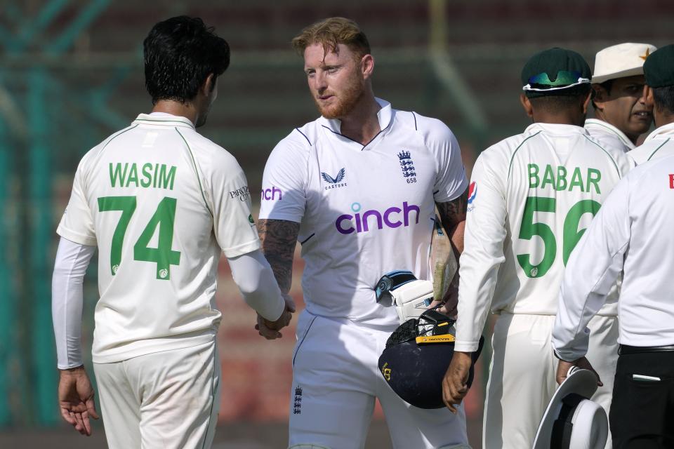 England's skipper Ben Stokes, center, shakes hand with Pakistani players after winning the third test cricket match against Pakistan, in Karachi, Pakistan, Tuesday, Dec. 20, 2022. (AP Photo/Fareed Khan)