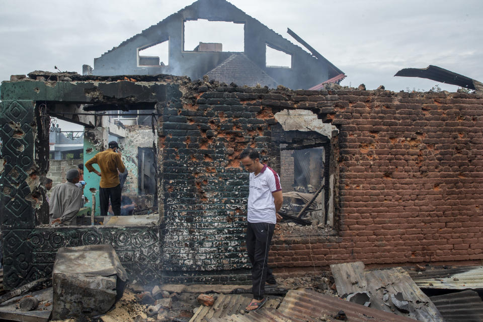 Kashmiri villagers inspect a house destroyed in a gunfight in Pulwama, south of Srinagar, Indian controlled Kashmir, Wednesday, July 14, 2021. Three suspected rebels were killed in a gunfight in Indian-controlled Kashmir on Wednesday, officials said, as violence in the disputed region increased in recent weeks. Two residential houses were also destroyed. (AP Photo/ Dar Yasin)