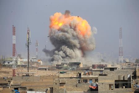 FILE PHOTO: Smoke rises after an airstrike, during the battle against Islamic State militants, at the district of al-Mamoun in Mosul, Iraq, March 1, 2017. REUTERS/Alaa Al-Marjani