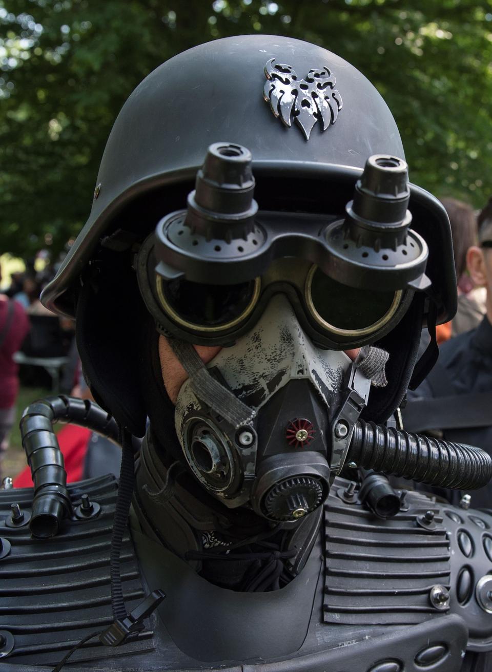 <p>A participant of the so called “Victorian Picnic” walks in a fancy costume during the Wave Gothic Festival (WGT) in Leipzig, Germany, Friday, June 2, 2017. (AP Photo/Jens Meyer) </p>