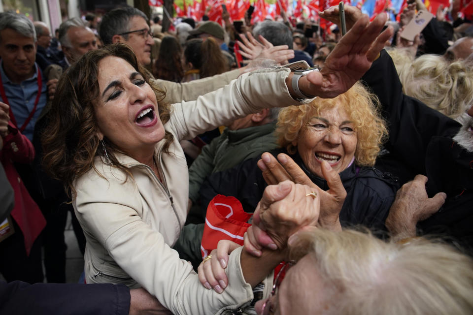 Spain's First Deputy Prime Minister and Finance Minister María Jesús Montero, left, attends a demonstration in support of Prime Minister Pedro Sánchez who threatened to resign after a court opened preliminary proceedings against his wife on corruption allegations, in Madrid, Spain, April 27, 2024. (AP Photo/Andrea Comas)