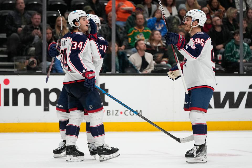 The Blue Jackets' Cole Sillinger (34) celebrates his goal with Jack Roslovic (96) and Kent Johnson on Friday. It was Sillinger's first goal since Nov. 17.