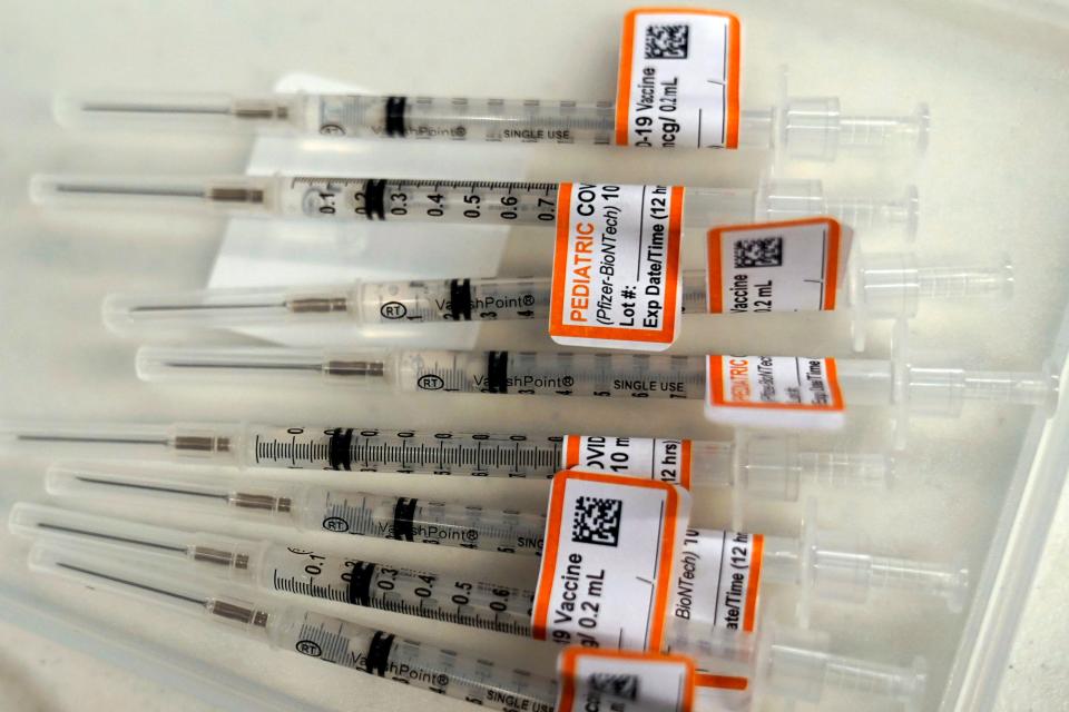 Prepared Pfizer COVID-19 vaccine syringes for children ages 5 to 11 and adults are displayed on a table at Northwest Community Church in Chicago.