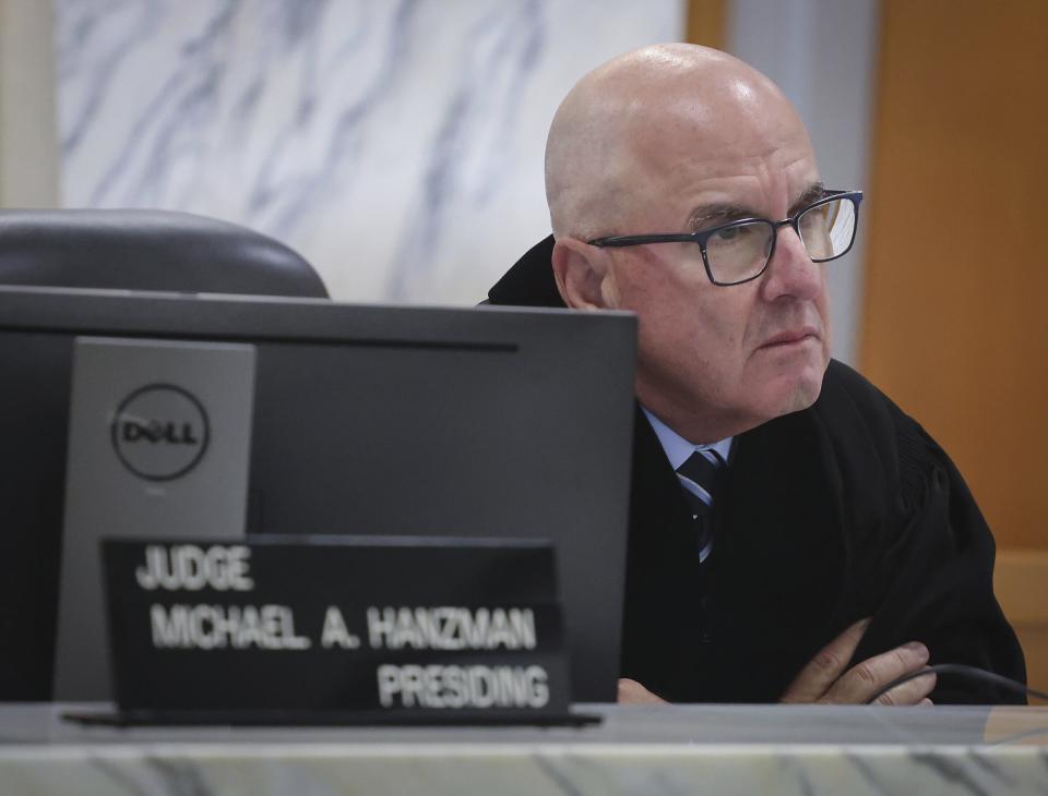 Miami-Dade Circuit Judge Michael Hanzman listens as tenants share their thoughts regarding the future of the site of the Champlain Towers South building that collapsed in Surfside, Fla., during a hearing, Wednesday, July 21, 2021, in Miami. Hanzman said victims and families who suffered losses in the collapse of the 12-story oceanfront Florida condominium will get a minimum of $150 million in compensation initially. (Carl Juste/Miami Herald via AP, Pool)