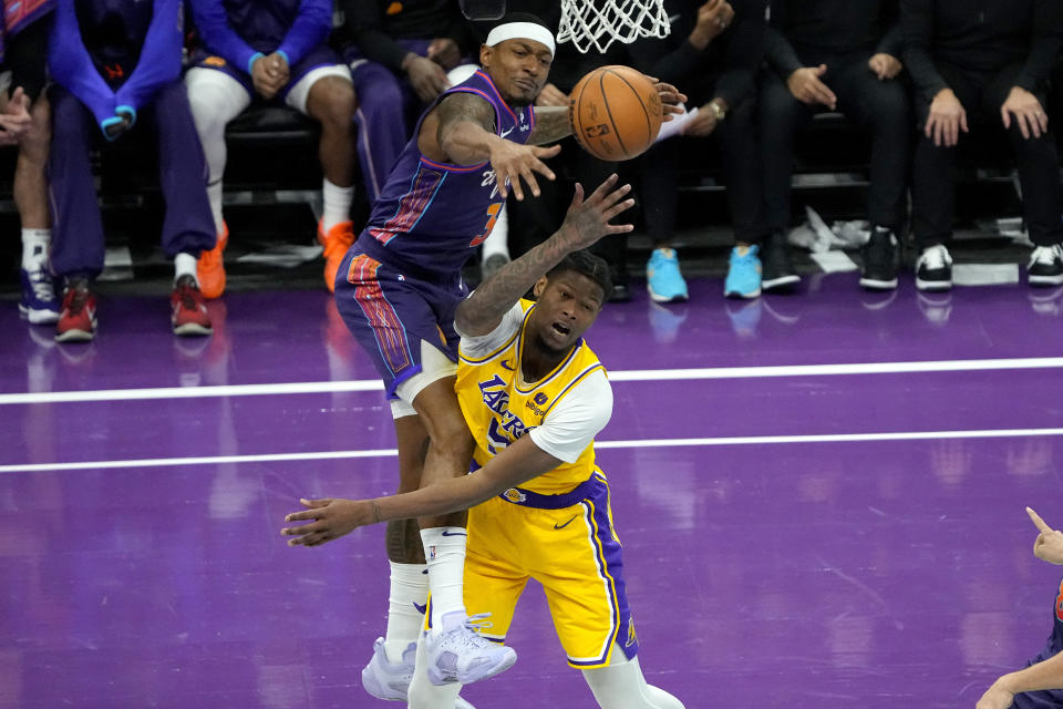 Phoenix Suns guard Bradley Beal fouls Los Angeles Lakers forward Cam Reddish, right, during the during the second half of an NBA basketball in-season tournament game, Friday, Nov. 10, 2023, in Phoenix. (AP Photo/Matt York)