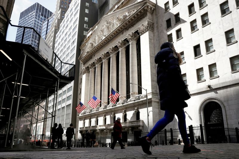 FILE PHOTO: People are seen on Wall Street outside the NYSE in New York