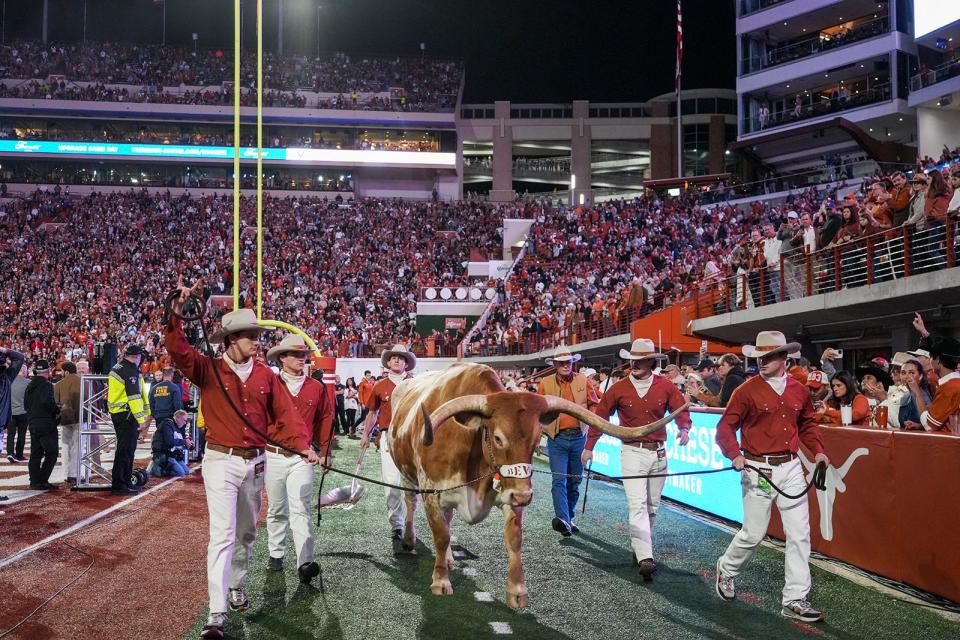 Texas mascot Bevo strolls into Royal-Memorial Stadium before the Longhorns' win over Texas Tech last week. Texas ended the season ranked atop the Big 12's media poll.