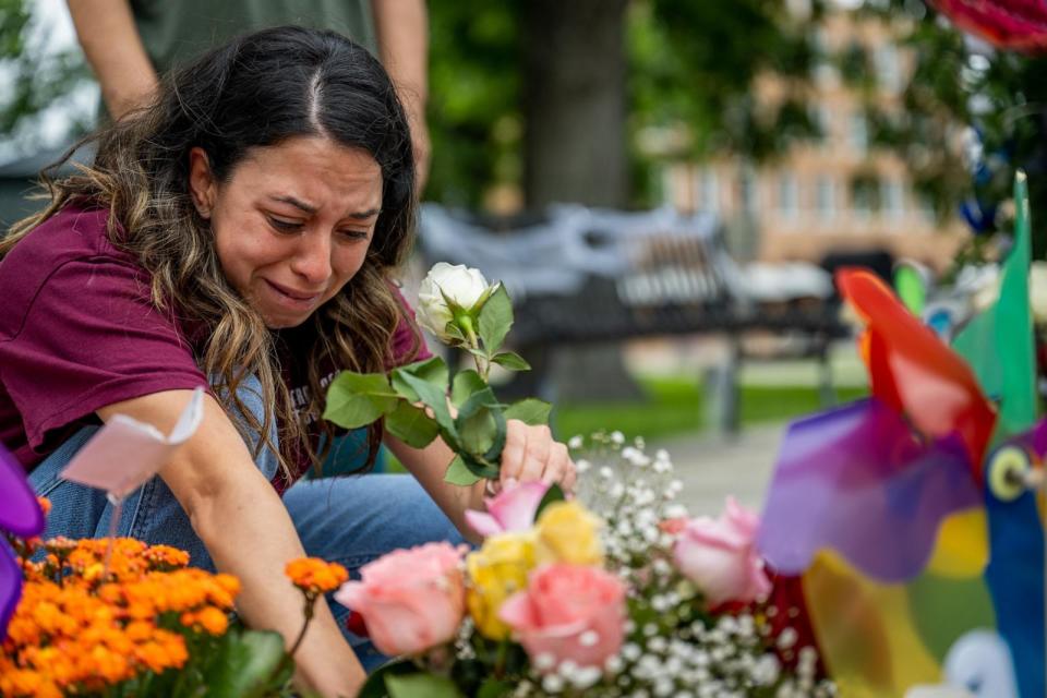 PHOTO: Angeli Rose Gomez, a mother who rushed into Robb Elementary School to save her two children, places roses down at a memorial dedicated to the victims on May 24, 2022. (Brandon Bell/Getty Images, FILE)