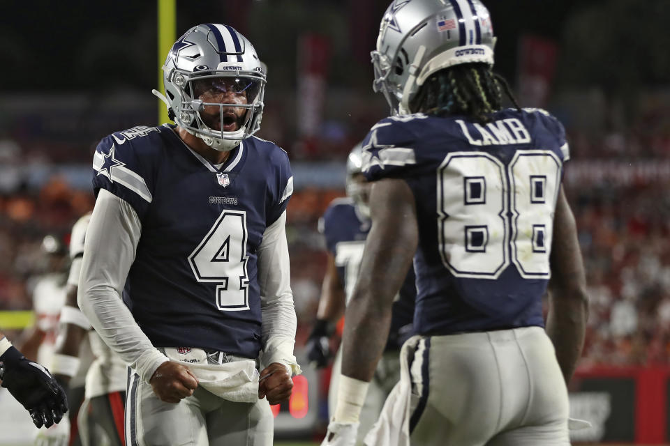 Dallas Cowboys quarterback Dak Prescott (4) celebrates with wide receiver CeeDee Lamb (88) after a touchdown against the Tampa Bay Buccaneers during the first half of an NFL football game Thursday, Sept. 9, 2021, in Tampa, Fla. (AP Photo/Mark LoMoglio)