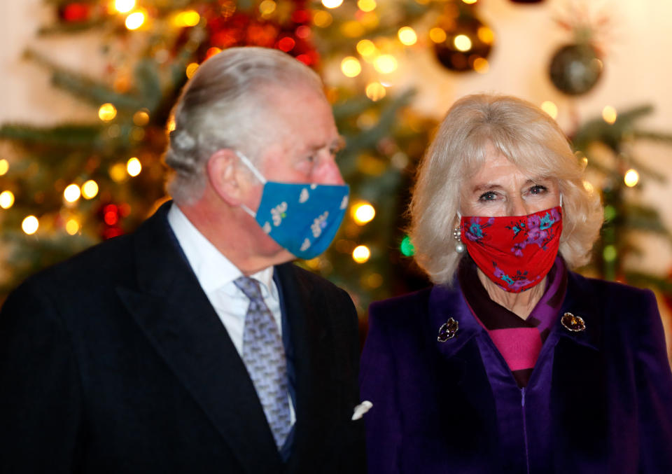 WINDSOR, UNITED KINGDOM - DECEMBER 08: (EMBARGOED FOR PUBLICATION IN UK NEWSPAPERS UNTIL 24 HOURS AFTER CREATE DATE AND TIME) Prince Charles, Prince of Wales and Camilla, Duchess of Cornwall wear a face masks as they attend an event to thank local volunteers and key workers from organisations and charities in Berkshire, who will be volunteering or working to help others over the Christmas period in the quadrangle of Windsor Castle on December 8, 2020 in Windsor, England. During the event members of the Royal Family also listened to Christmas carols performed by The Salvation Army Band. (Photo by Max Mumby/Indigo - Pool/Getty Images)