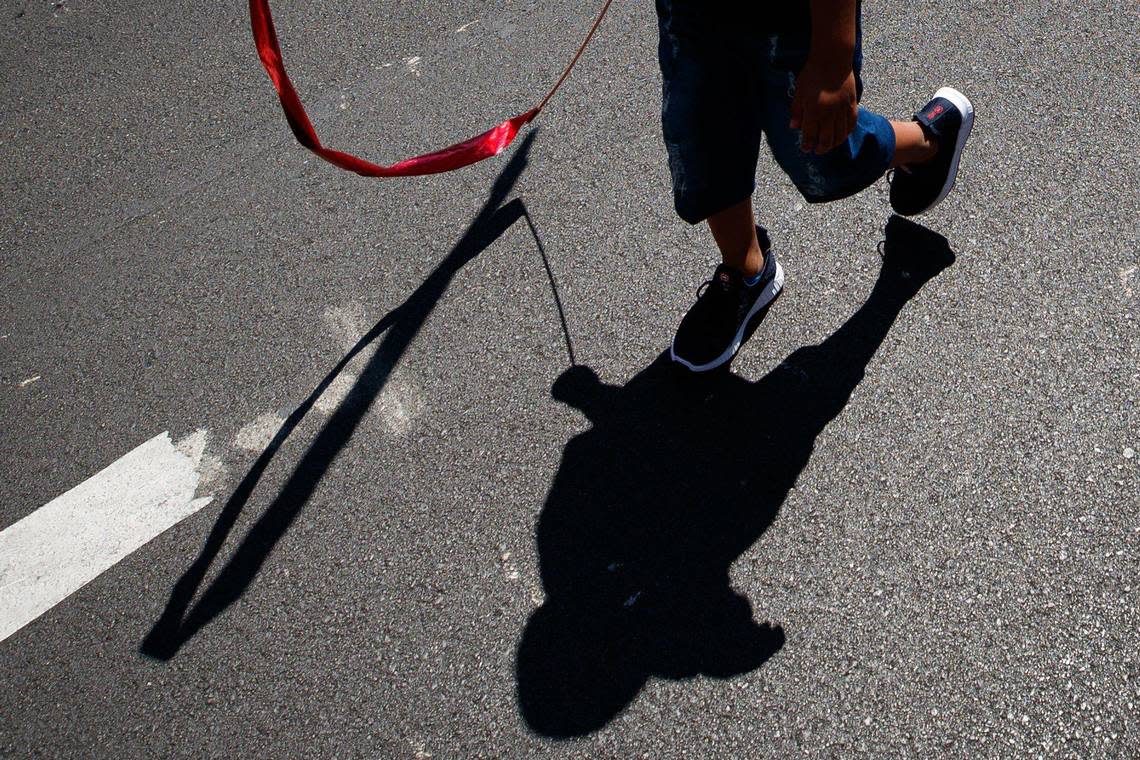 A child walks with a ribbon during the City of Lexington’s Fourth of July celebration parade on Monday, July 4, 2022, on Main Street in Lexington, Kentucky.