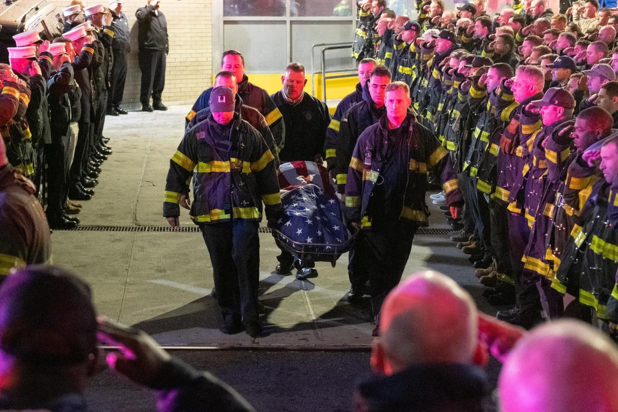 FDNY members salute as the body of firefighter Timothy Klein is removed from Brookdale Hospital in Brooklyn, New York City on Sunday.