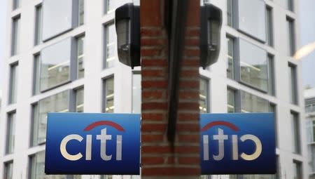A Citibank sign is reflected in a window in the City of London November 12, 2014. REUTERS/Stefan Wermuth
