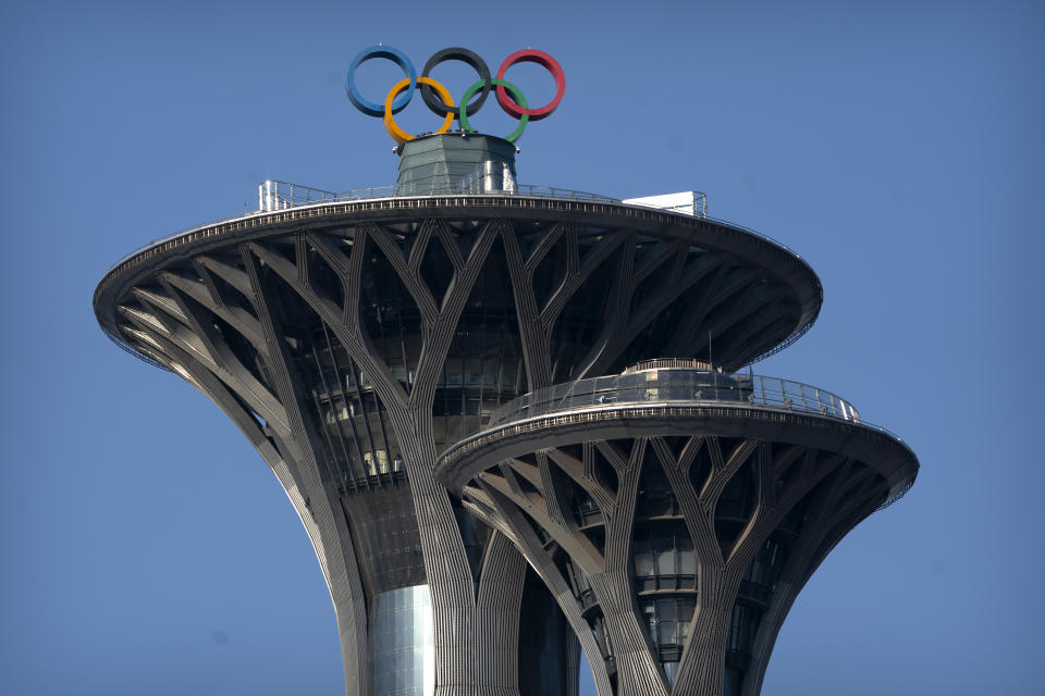 The Olympic rings are visible atop the Olympic Tower in Beijing, Tuesday, Feb. 2, 2021. The 2022 Beijing Winter Olympics will open a year from now. Most of the venues have been completed as the Chinese capital becomes the first city to hold both the Winter and Summer Olympics. Beijing held the 2008 Summer Olympics. But these Olympics are presenting some major problems. They are already scarred by accusations of rights abuses including "genocide"against more than 1 million Uighurs and other Muslim ethnic groups in western China. (AP Photo/Mark Schiefelbein)