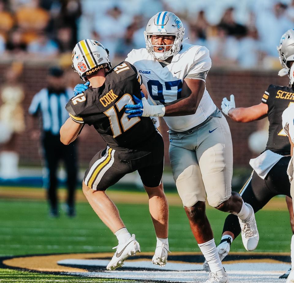 MTSU defensive lineman Quindarius Dunnigan (97) sacks Missouri quarterback Brady Cook during Saturday's 23-19 Tiger win.