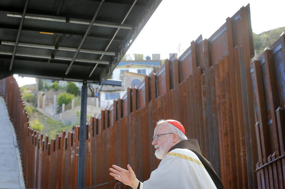 Boston Archdiocese Cardinal Sean O'Malley leads mass, Tuesday, April 1, 2014, along the international border wall in Nogales, Ariz. A delegation of Roman Catholic leaders celebrated Mass along the U.S.-Mexico border to raise awareness about immigration and to pray for policy changes. (AP Photo/Matt York)