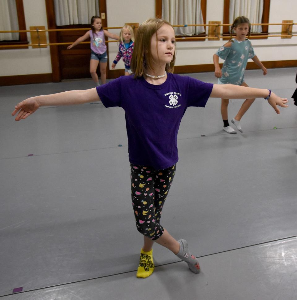 Ireland Mason, 8, takes part in the grapevine sliding move across the stage as part of the dance portion of the Summer Theatre Arts Camp at River Raisin Centre for the Arts in Monroe.