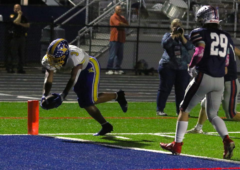 West Muskingum's Rashid SeSay reaches over the goal line for one of his school record six touchdowns in a 42-13 win over Morgan. SeSay was one of the finalists named for Mr. Football.