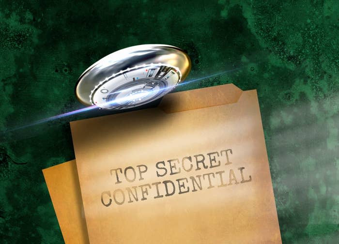 A UFO hovers over a folder labeled "Top Secret Confidential" shining light onto it