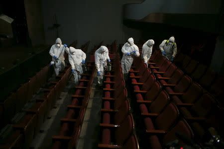 Employees from a disinfection service company sanitize the interior of a theater in Seoul, South Korea, June 18, 2015. REUTERS/Kim Hong-Ji