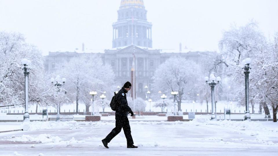 PHOTO: Matthew Palmeri heads to work at snow covered Civic Center Park in Denver, Colorado, March 14, 2024.  (Hyoung Chang/Denver Post via Getty Images)