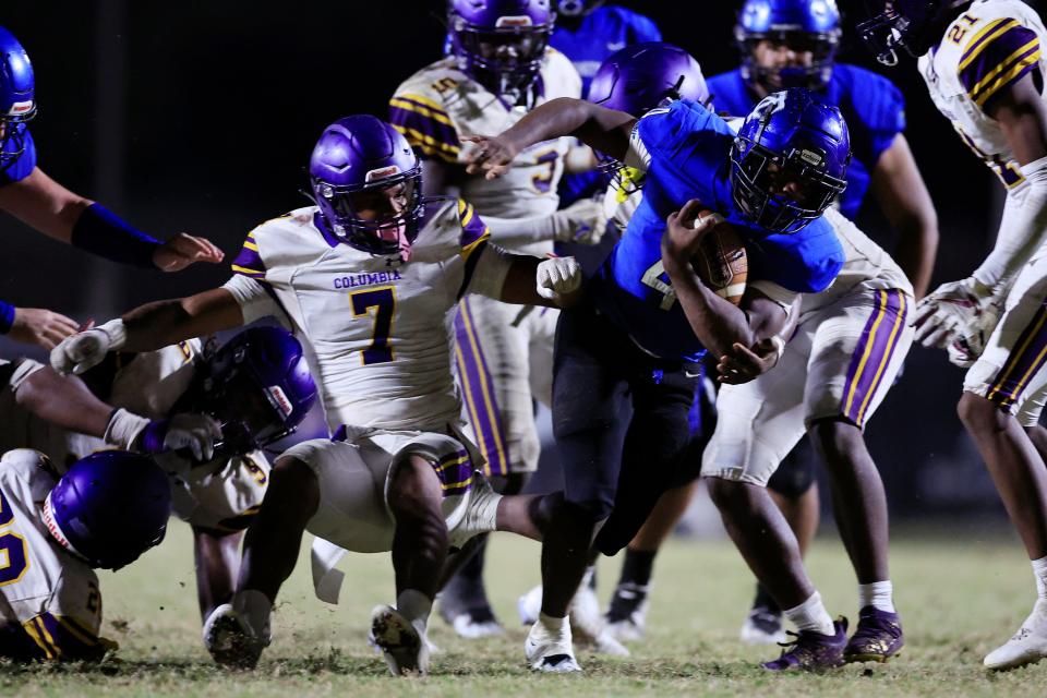 Trinity Christian Academy's Darnell Rogers (4) rushes for yards against Columbia's Amare Ferrell (7) during the third quarter of a regular season football game Friday, Sept. 23, 2022 at Trinity Christian Academy in Jacksonville. Trinity Christian Academy defeated the Columbia Tigers 43-30.  