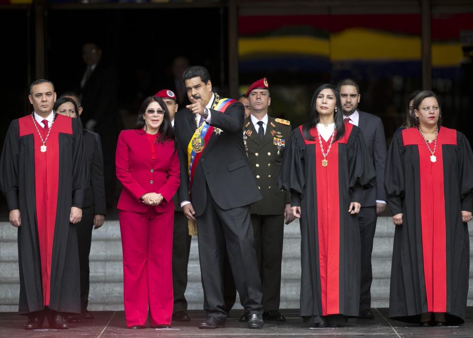 FILE - In this Jan. 15, 2017 file photo, Venezuela's President Nicolas Maduro speaks with first lady Cilia Flores as they arrive to the Supreme Court, before delivering his state of the union address, in Caracas, Venezuela. Venezuela's Supreme Court ruled Wednesday night, that it can take over responsibilities assigned to Congress. Maduro opponents are saying it's part of an attempt to install a dictatorship in the South American nation. Justices pictured from left to right; Supreme Court Vice President Maikel Moreno; Supreme Court President Gladys Gutierrez; and Supreme Court Justice Indira Alfonso. (AP Photo/Ariana Cubillos, File)