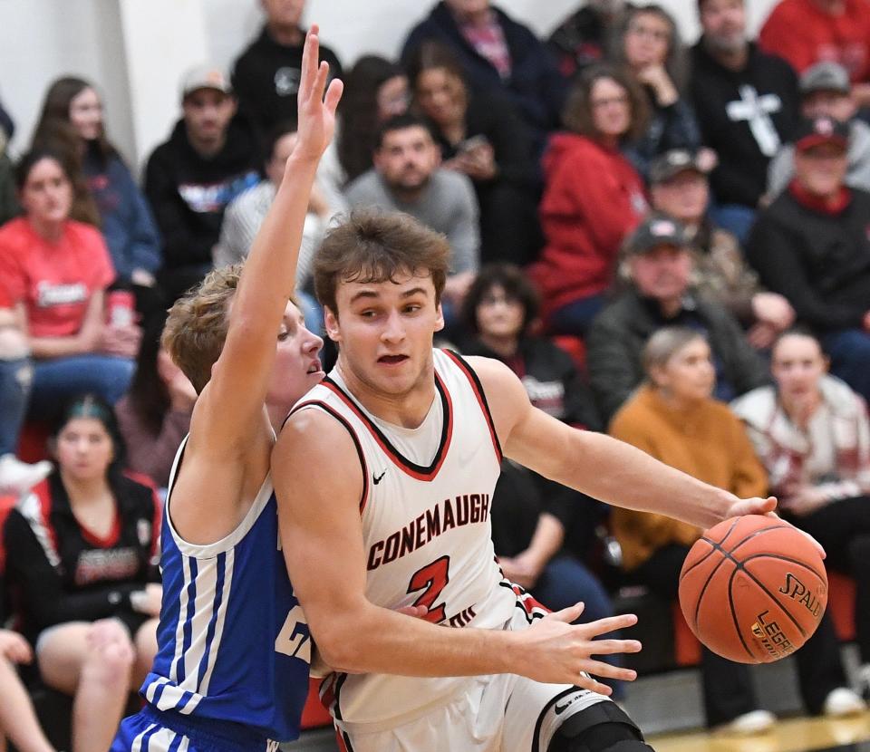 Conemaugh Township's Jon Updyke is defended by Windber's Grady Klosky on his way to the basket during a boys WestPAC basketball contest, Jan. 5, in Davidsville.