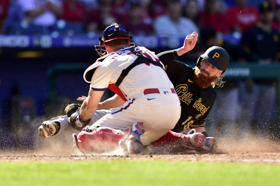 Pittsburgh Pirates' Colin Moran, right, is tagged out at home plate by Philadelphia Phillies' J.T. Realmuto (10) on a double hit by Ke'Bryan Hayes during the seventh inning of a baseball game, Sunday, Sept. 26, 2021, in Philadelphia. (AP Photo/Derik Hamilton)