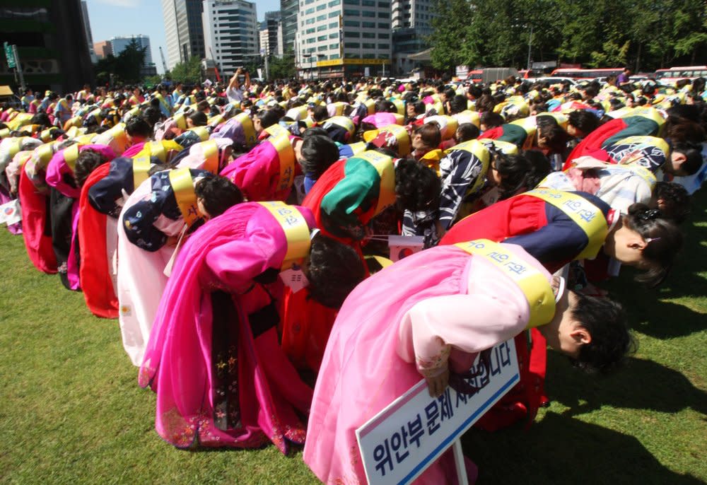 Japanese members of the church bow as an act of apology for the war during a rally ahead of an anniversary celebration of Korea’s liberation from Japan’s colonial rule, in Seoul, Aug. 14, 2012. <span class="copyright">Ahn Young-joon—AP</span>