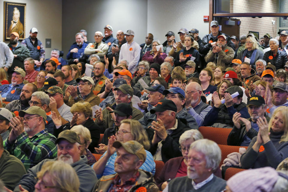 Spectators applaud as the Buckingham County Board of Supervisors unanimously voted to pass a Second Amendment Sanctuary City resolution at a meeting in Buckingham , Va., Monday, Dec. 9, 2019. The board passed the resolution without any public discussion. (AP Photo/Steve Helber)