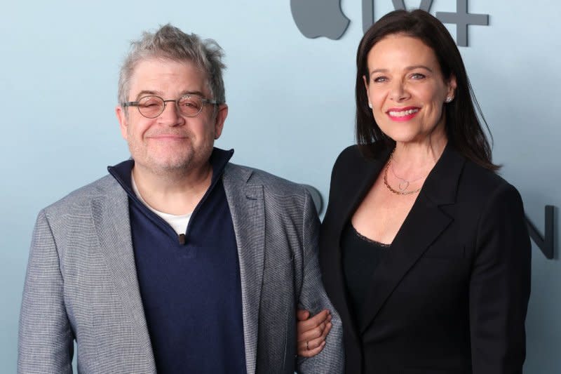 Patton Oswalt, seen with wife Meredith Salenger, hosts the American edition of "The 1% Club." File Photo by Greg Grudt/UPI