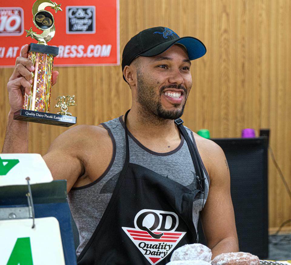 Akiem Harshman representing Judson Baptist Church wins the inaugural Quality Dairy paczki-eating contest by finishing four of the tasty Polish-style pastries in three minutes Friday, Jan. 26, 2024.