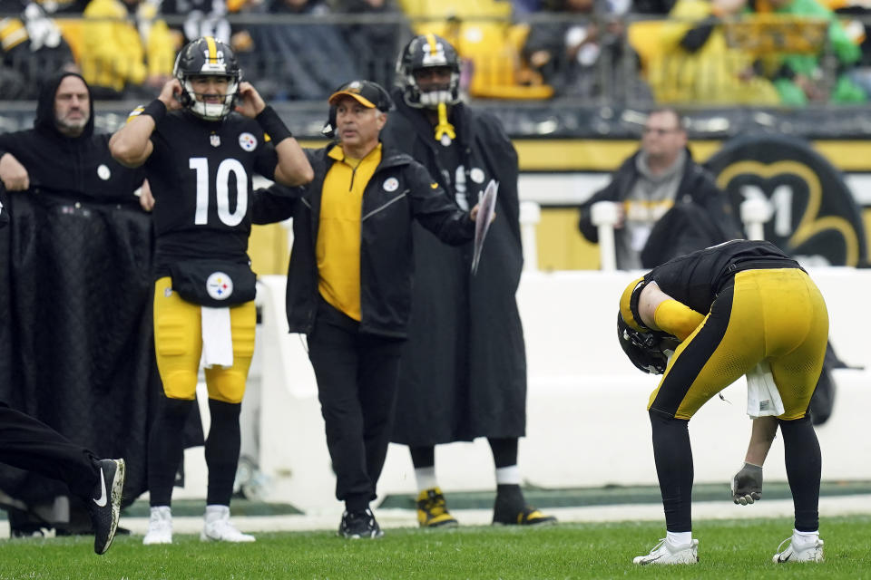 Pittsburgh Steelers quarterback Kenny Pickett, right, doubles over as he leaves the field after getting shaken up against the Jacksonville Jaguars during the first half of an NFL football game Sunday, Oct. 29, 2023, in Pittsburgh. Quarterback Mitch Trubisky (10) prepares to come into the game. (AP Photo/Matt Freed)