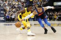 Dec 13, 2017; Indianapolis, IN, USA; Oklahoma City Thunder guard Russell Westbrook (0) knocks the ball away from Indiana Pacers guard Victor Oladipo (4) during the 4th quarter at Bankers Life Fieldhouse. Brian Spurlock-USA TODAY Sports