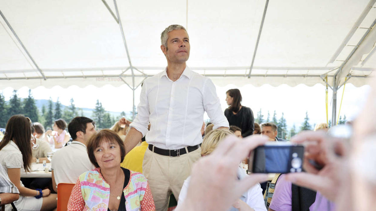 Mayor of Le Puy-en-Velay and right-wing UMP deputy Laurent Wauquiez (C) speaks with activists and members of the UMP party before his traditional climb of the Mont Mezenc near Estables, central france, on August 18, 2013. AFP PHOTO / ROMAIN LAFABREGUE (Photo by ROMAIN LAFABREGUE / AFP)