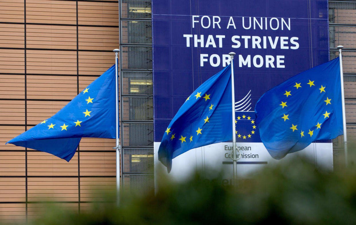 European Union flags flap in the wind outside EU headquarters in Brussels, Monday, Jan. 27, 2020. The U.K. is due to leave the EU on Friday, the first nation in the bloc to do so. It then enters an 11-month transition period in which Britain will continue to follow the bloc's rules while the two sides work out new deals on trade, security and other areas., 2020. (AP Photo/Virginia Mayo)