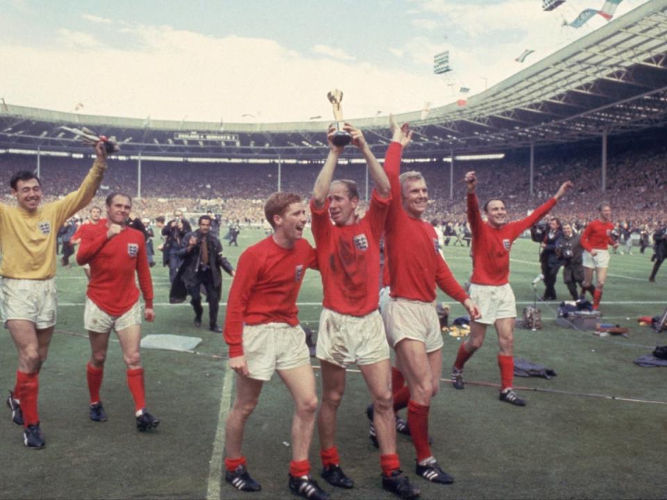 Bobby Charlton, centre, celebrates with the World Cup at Wembley (Getty Images)