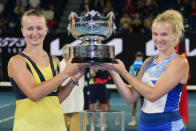 Czech Republic's Barbora Krejcikova, left, and Katerina Siniakova hold their trophy aloft after defeating Japan's Shuko Aoyama and Ena Shibahara in the women's doubles final at the Australian Open tennis championship in Melbourne, Australia, Sunday, Jan. 29, 2023. (AP Photo/Aaron Favila)