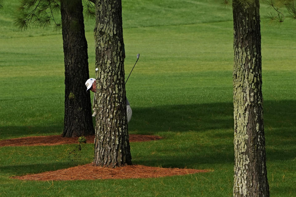 Lee Westwood, of England, hits from behind a tree on the seventh hole during the first round of the Masters golf tournament Thursday, Nov. 12, 2020, in Augusta, Ga. (AP Photo/Matt Slocum)