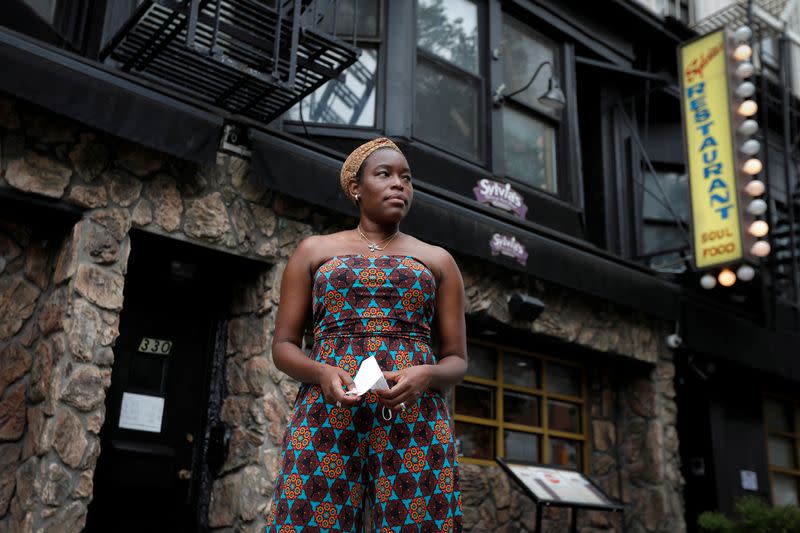 Tren'ness Woods-Black, granddaughter of the late Sylvia Woods, poses outside Sylvia's Restaurant in Harlem in New York