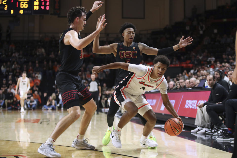 Southern California forward Harrison Hornery, left, and guard Boogie Ellis defend against Oregon State guard Josiah Lake II during the second half of an NCAA college basketball game Saturday, Dec. 30, 2023, in Corvallis, Ore. Oregon State won 86-70. (AP Photo/Amanda Loman)