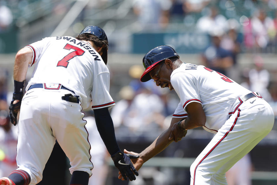Atlanta Braves Dansby Swanson (7) rounds third and reacts with third base coach Ron Washington after a home run in the fourth inning of a baseball game against the San Francisco Giants, Thursday, June 23, 2022, in Atlanta. (AP Photo/Todd Kirkland)