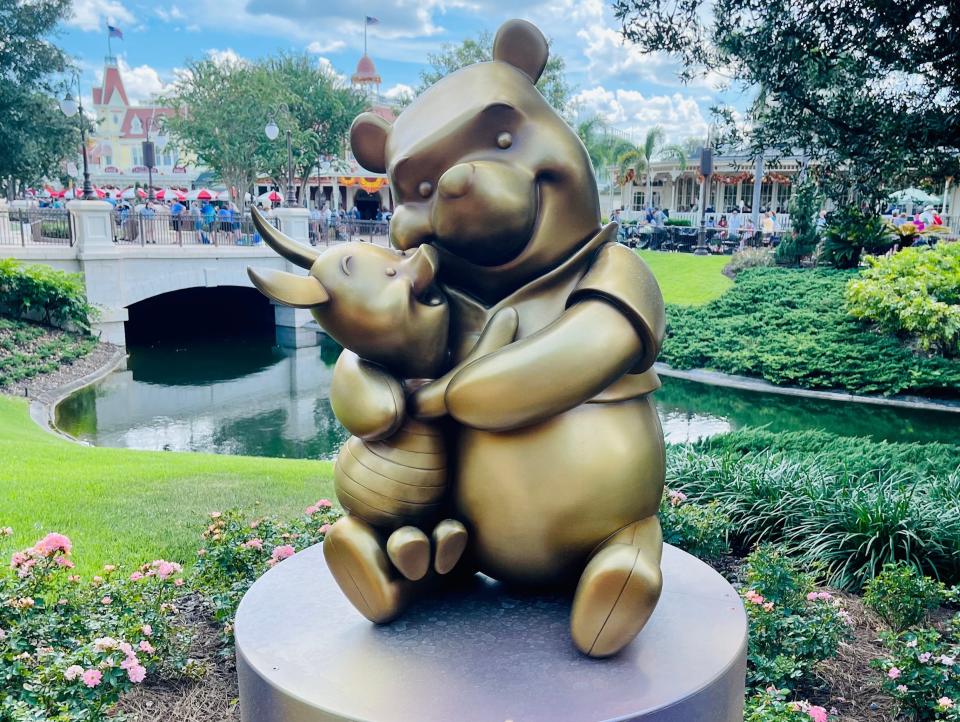 statue of pooh bear and piglet at magic kingdom for 50th anniversary