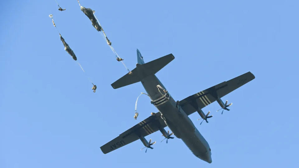 U.S. paratroopers conduct an airborne jump from a C-130J. <em>U.S. Army/Miriam Schraml</em>