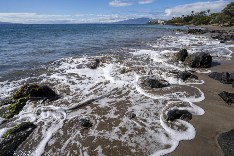 The tide circulates around rocks as it rises at Wahikuli Wayside Park on Friday, Nov. 3, 2023, in Lahaina, Hawaii. (AP Photo/Mengshin Lin)